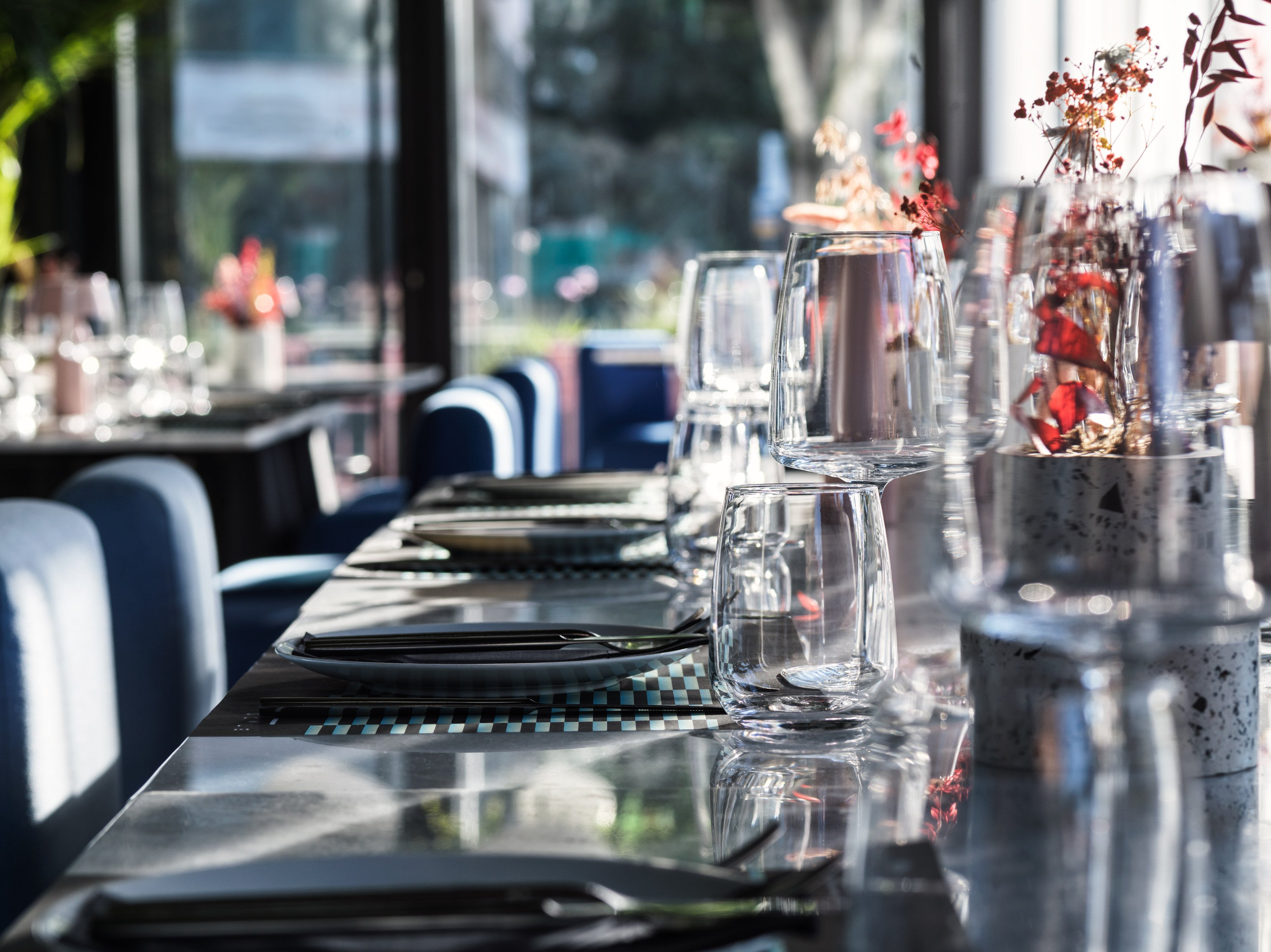 Restaurant table set with glassware and elegant evening light.
