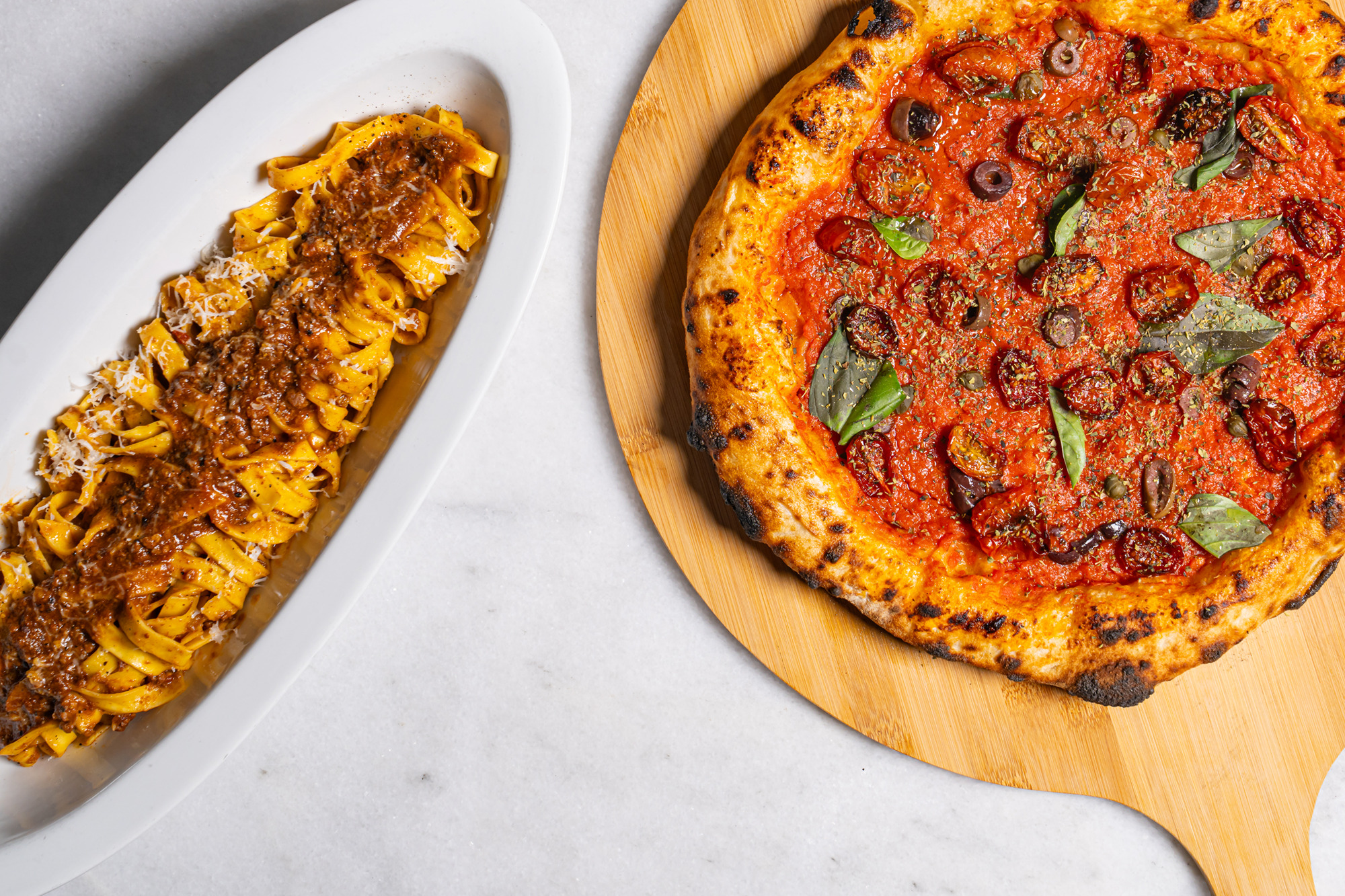 Tagliatelle bolognese and Neapolitan pizza at SCALE Restaurant Chapter I Italy